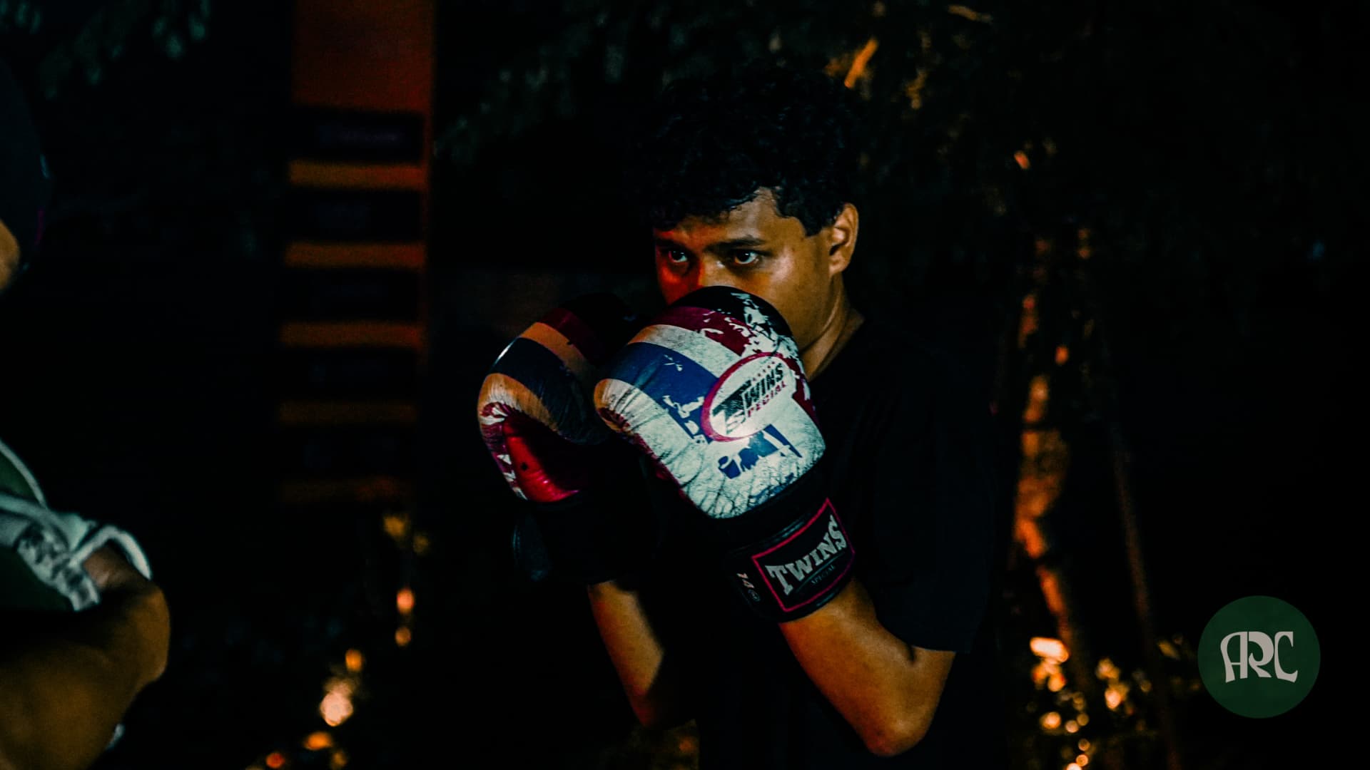Boxer focused in guard during an evening Fight Club session