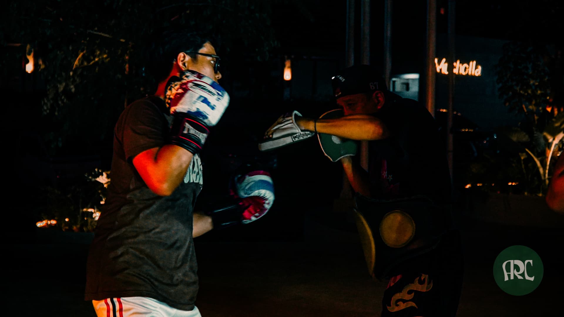 Fight Club member practicing a punch combination with a coach