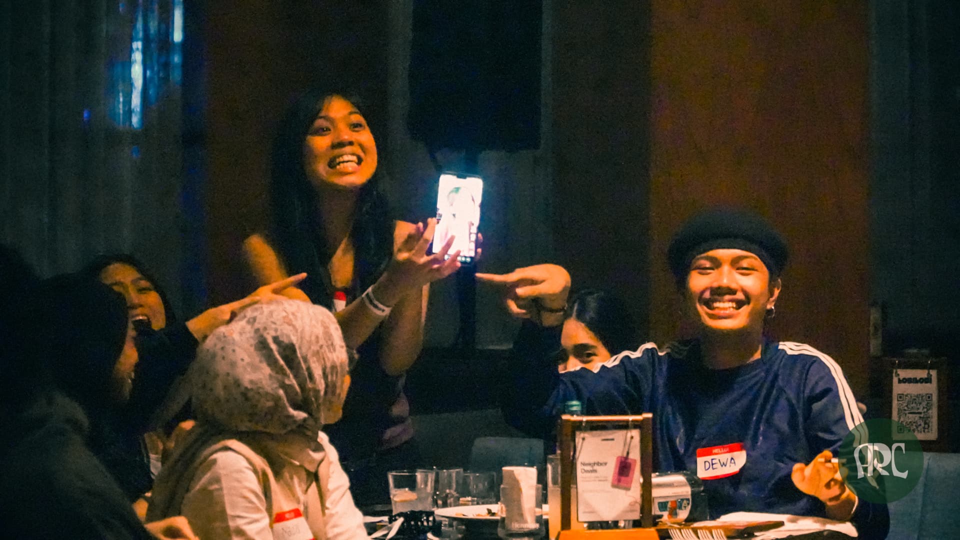 Players laughing and pointing during a trivia answer reveal